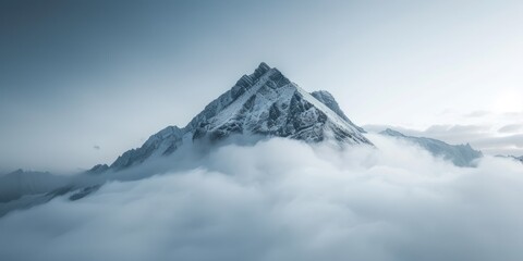 nspirational Photograph of a Mountain Rising Above the Clouds. Dramatic Shot of the Natural World.