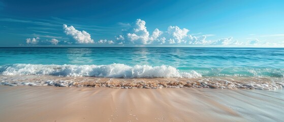 Serene beach with gentle waves and a clear blue sky