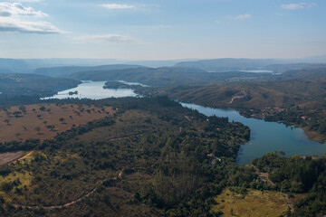 Fototapeta premium Aerial view of mountains and dam on the Rio Grande, in Pedregulho, Sao Paulo