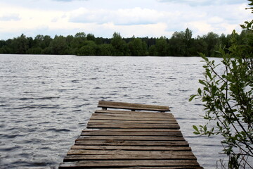 Fototapeta premium Wooden bridge near the lake shore.