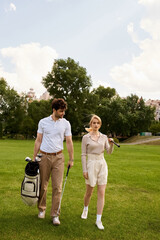 Fototapeta premium A stylish couple in elegant attire walking together on a lush green golf course under the open sky.