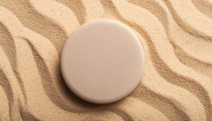 Obraz premium Round stone platform on sandy beach. Pedestal for product presentation. Mock-up. Flat lay