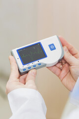 Display of cardiology equipment showing various readings and functions.

