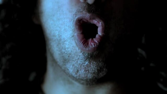 SINGER WITH LONG HAIR SINGING IN SLOW MOTION FACING THE CAMERA SYMMETRIC COMPOSITION