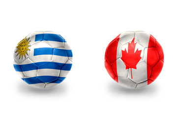 Obraz premium football balls with national flags of uruguay and canada ,soccer teams. on the white background.