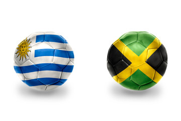 Obraz premium football balls with national flags of uruguay and jamaica ,soccer teams. on the white background.