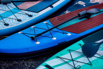 SUP boats lie on the riverbank.