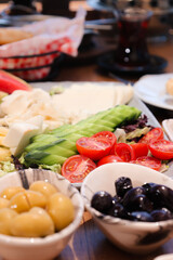 A colorful Turkish breakfast spread with a variety of foods including vegetables, cheese, and olives, perfect for a healthy start to the day.