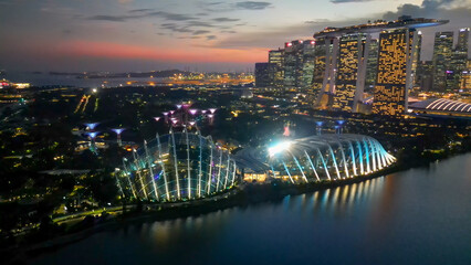 Obraz premium Singapore and Marina Bay skyscrapers. Aerial view at night from drone
