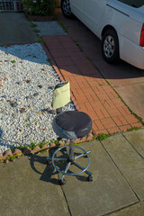 Old office chair given away for free on a sidewalk