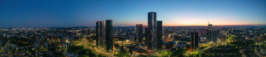 A breathtaking panoramic night view of Manchester featuring Deansgate and The Great Jackson Street skyscraper district