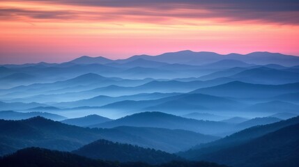 Obraz premium A picturesque view of the Blue Ridge Mountains at sunset, showcasing the layered peaks and a sky with hues of pink and orange.