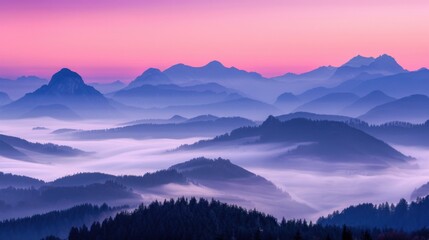 Obraz premium A panoramic view of a misty mountain landscape at sunrise with a pink and purple sky.
