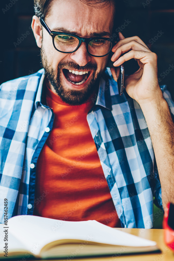 Aufkleber furious bearded hipster guy shouting during phone conversation on digital smartphone.angry young man
