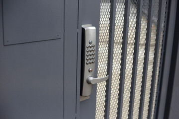 Electronic lock closure with keypad and steel handle on metal strip security door
