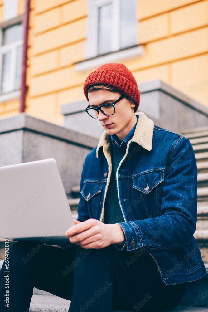 Poster pensive hipster student reading mail and notification on laptop computer connected to free 4g intern