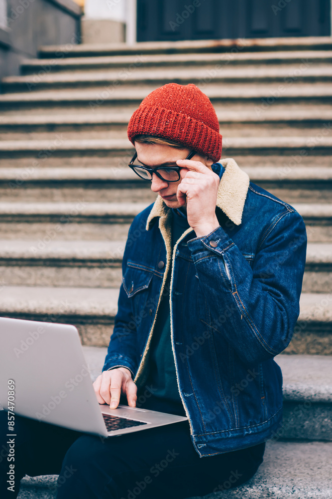 Poster concentrated hipster blogger searching information on websites and working on publication at modern 