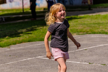 Young Girl Playing a Game on a Sunny Day in a Park