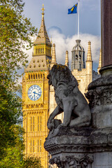 Lion statue and Big Ben tower, London, UK