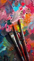 Colorful paintbrushes on a palette with mixed oil paints, top view. Artistic creativity and expression concept