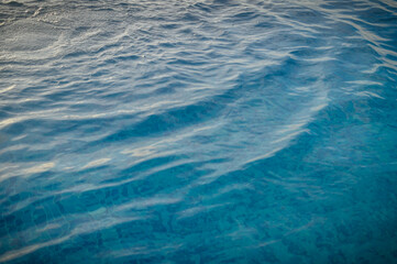 Ripple Water in swimming pool with sun reflection