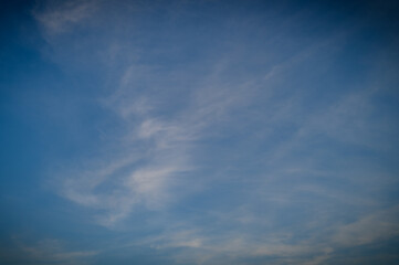 Beautiful white clouds on blue sky over calm sea with sunlight reflection