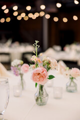 Little flowers in vases at a wedding reception. 