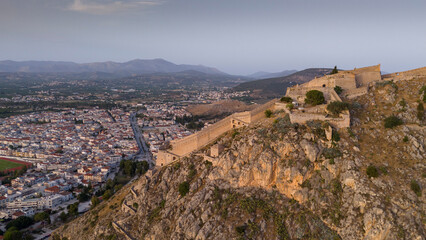 View from above on Nafplio city in Greece with port, Bourtzi fortress and blue Mediterranean sea soft focus