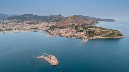 View from above on Nafplio city in Greece with port, Bourtzi fortress and blue Mediterranean sea soft focus