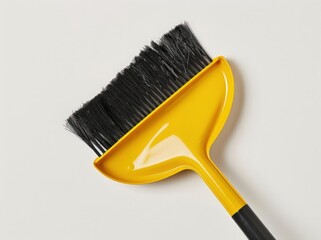 Yellow Broom Against White Background: Cleaning Tool with Black Bristles and Yellow Handle.