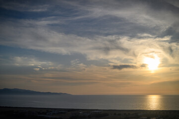 Blue sea and blue sky, beautiful waves. View from the beach to the rocky