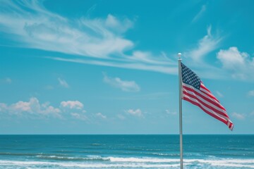Fototapeta premium Close up of an American flag waving in the wind with ocean and blue sky background United States national symbol for republic day and 4th of July Generative AI