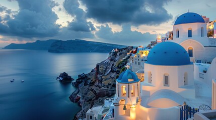 Obraz premium The iconic blue domes of Santorini glowing in the evening light
