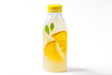 set orange with orange juice bottle in empty glass and ice