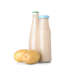 Bottles of tasty potato milk on white background