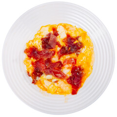 Delicious scrambled eggs with ham - a healthy hearty breakfast. Isolated over white background