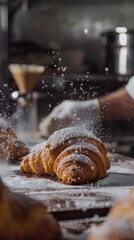 Freshly baked croissant dusted with powdered sugar in bakery