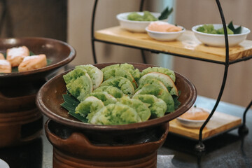 Serabi Pandan, Javanese Asian coconut-milk and pandanus pancakes with syrup of coconut milk and palm sugar. Served in traditional Java Indonesia Asia culture style