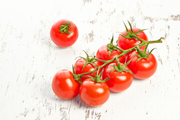 Cherry tomatoes on white wooden textured background. Close-up of cherry tomatoes.