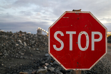 Traffic STOP sign next to mine haul road for dump trucks and other heavy vehicles