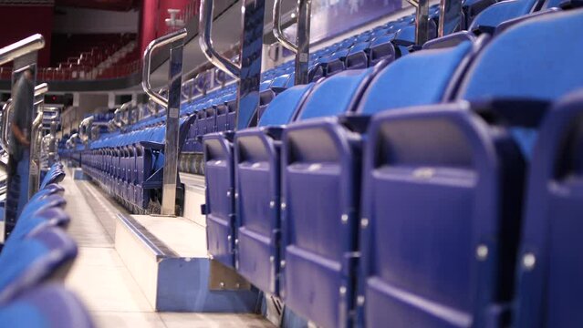 close-up of empty blue seats at the ice arena. folded chairs, seats