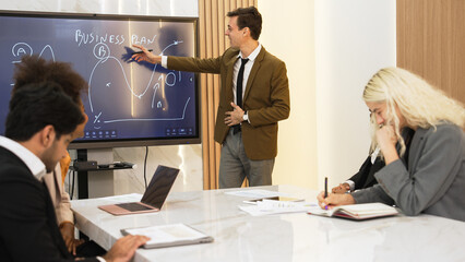 Presentation in ornamented meeting room with business professionals attending to project...