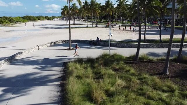 path to the beach riding skater girl top view from drone