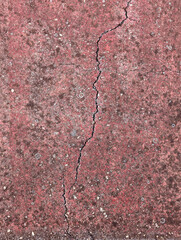 Worn asphalt tennis court floor with red paint, cracks, moisture and lichens top view texture or background.