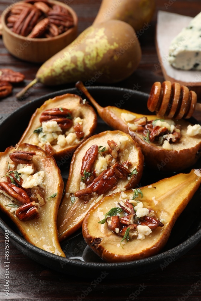Wall mural delicious baked pears with nuts, blue cheese and honey on wooden table, closeup - Wall murals