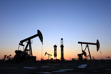 In the evening, oil pumps are running, Silhouette of beam pumping unit