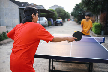 Potrait Of Young Asian Man Blocked Ping Pong Ball With Forehand. Single Ping Pong Match Outdoor