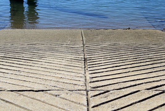 Concrete boat ramp with grooved lines leaving to the ocean