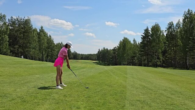 Woman Plays Golf on a Sunny Day in a Forest