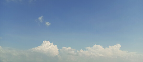 Wisps of white clouds against a beautiful blue sky background